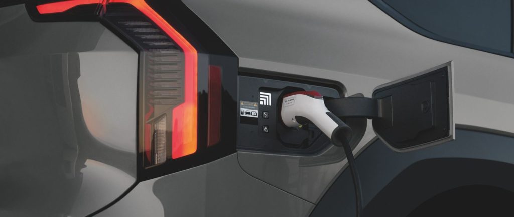 Close-up of a Kia EV charging port while the vehicle charges at Planet Kia Charlotte in North Carolina
